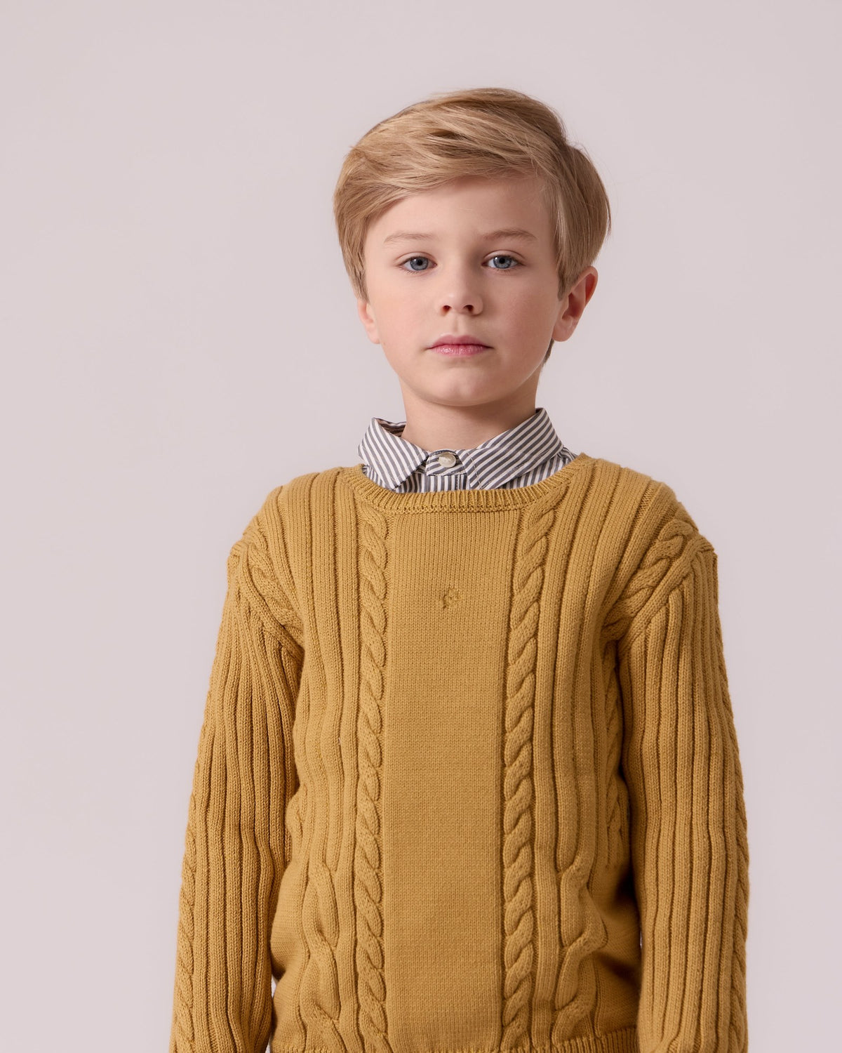 Boy in a mustard cable knit sweater, Cottier