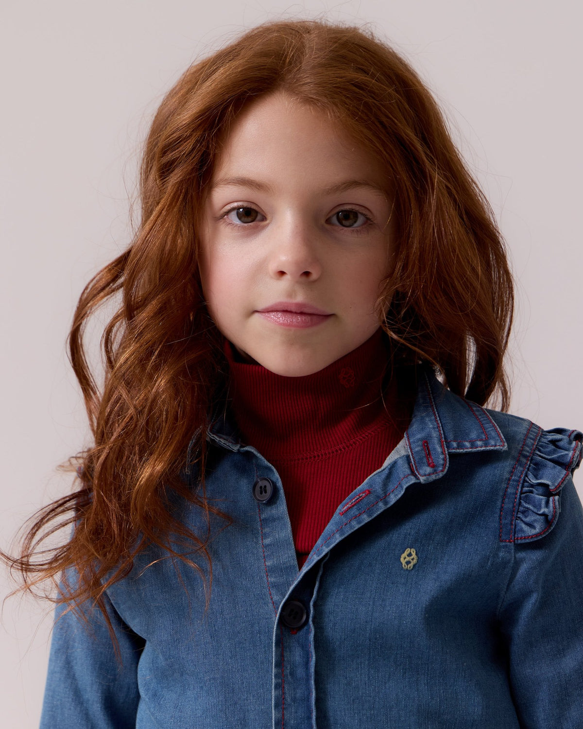 Girl in a denim Aria shirt and red turtleneck, Cottier